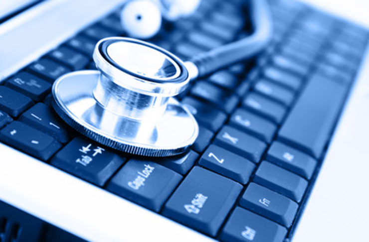 Close-up of stethoscope on laptop keyboard